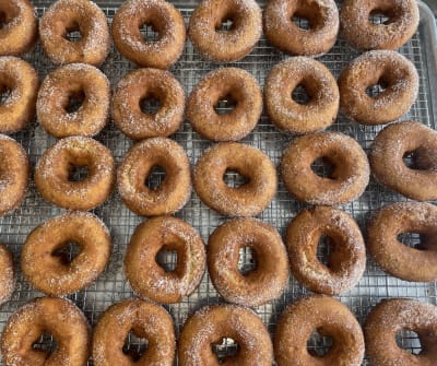 a tray covered in round brown donuts
