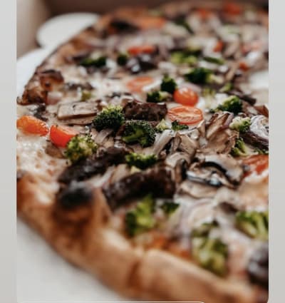 Close up of oven fired pizza